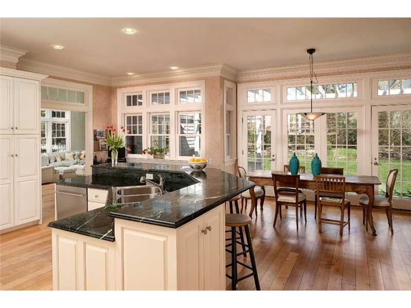 1021 Ponus Ridge Road New Canaan, CT 06840 - Photo 7 of 25 a kitchen with stainless steel appliances granite countertop a table chairs stove and kitchen view