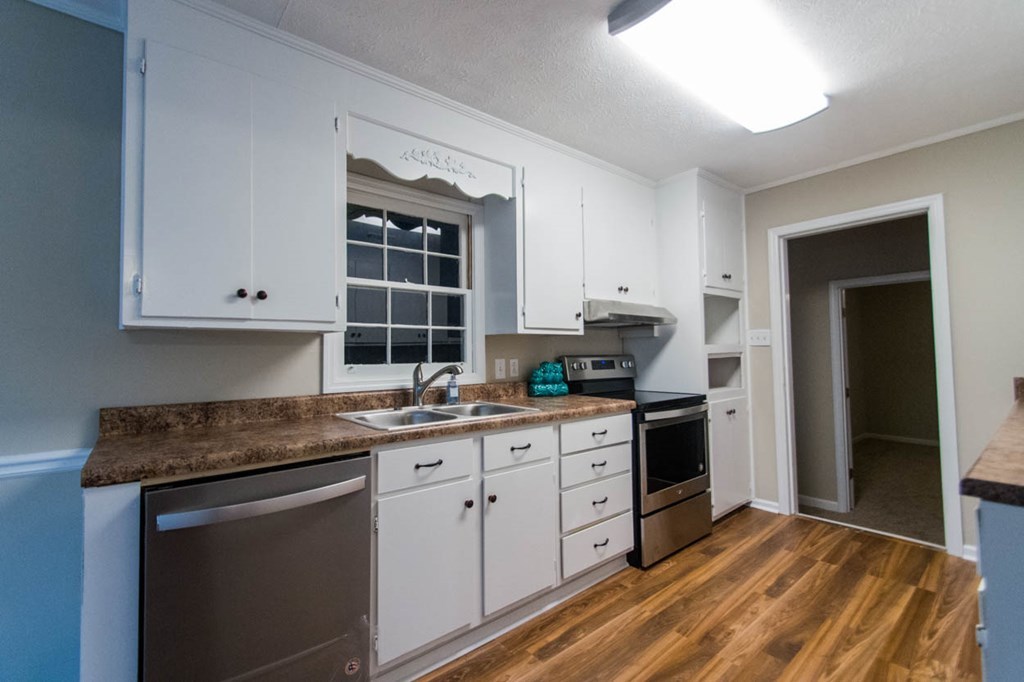 4841 Sandy Point Road Lizella, GA 31052 - Photo 12 of 42 a kitchen with granite countertop white cabinets and white appliances
