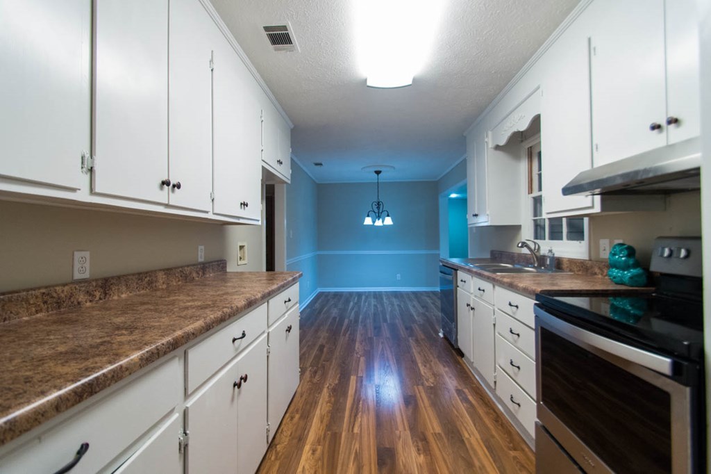 4841 Sandy Point Road Lizella, GA 31052 - Photo 13 of 42 a kitchen with granite countertop white cabinets and white appliances