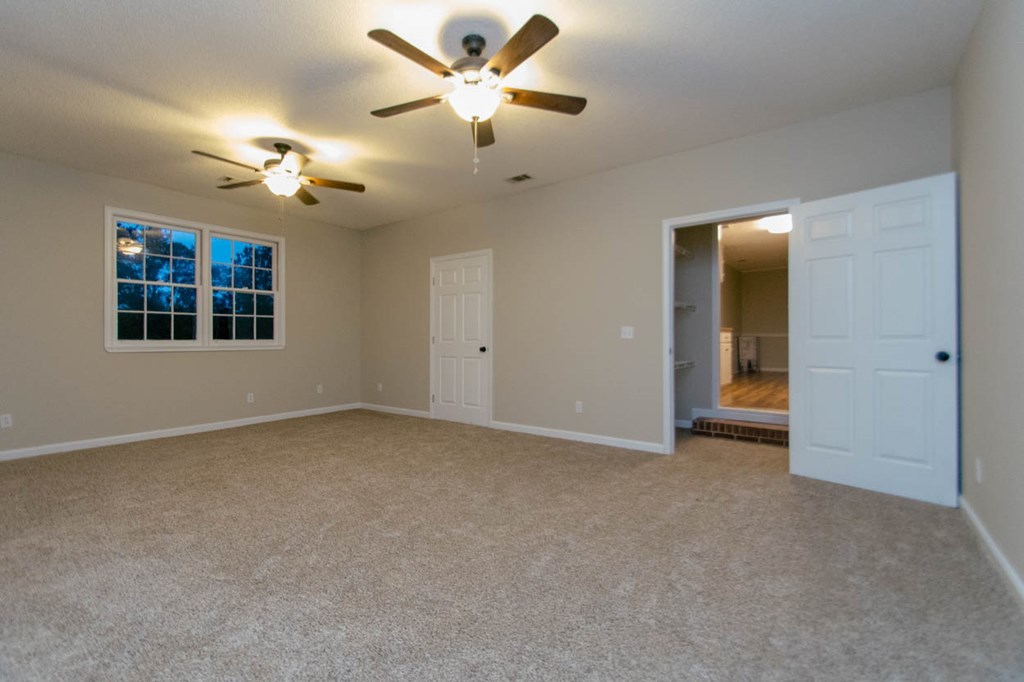 4841 Sandy Point Road Lizella, GA 31052 - Photo 16 of 42 an empty room with windows and fan