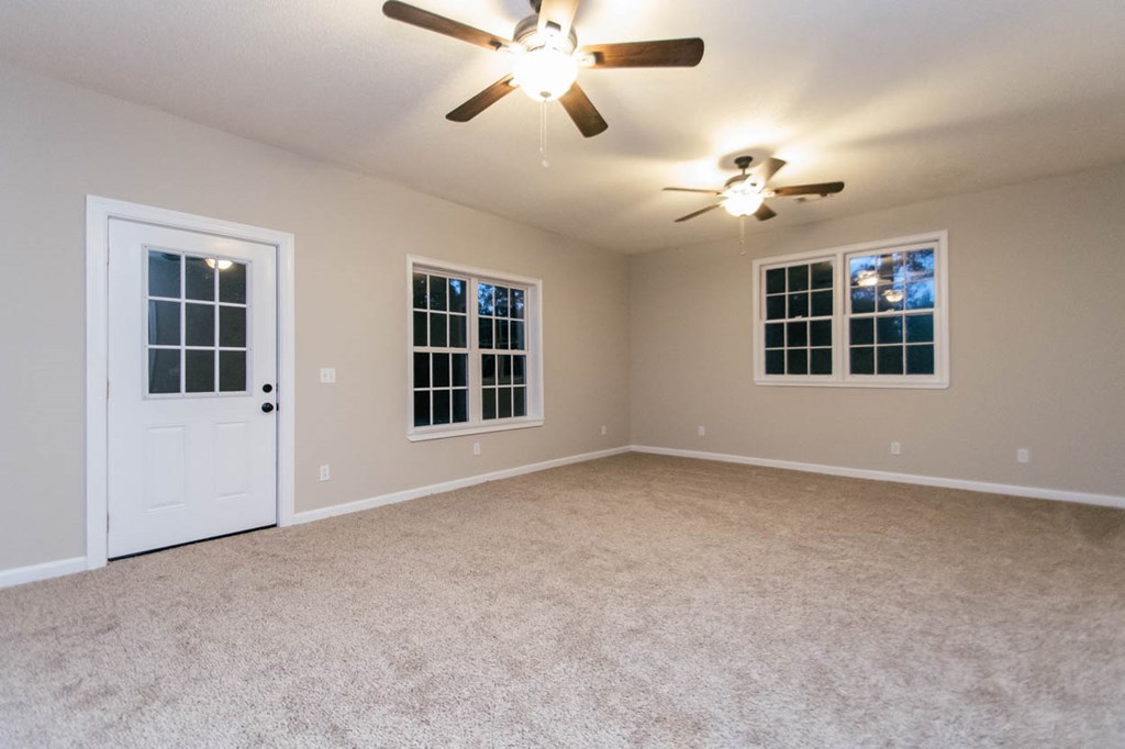 4841 Sandy Point Road Lizella, GA 31052 - Photo 17 of 42 a view of an empty room with a window and a ceiling fan