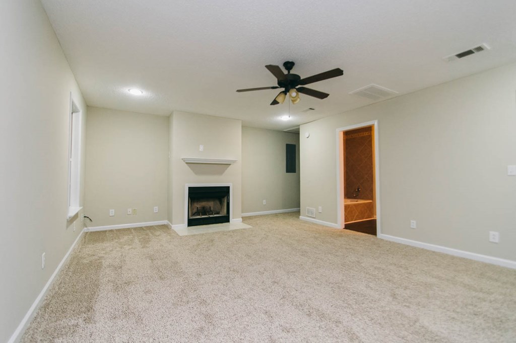 4841 Sandy Point Road Lizella, GA 31052 - Photo 28 of 42 an empty room with fireplace and windows