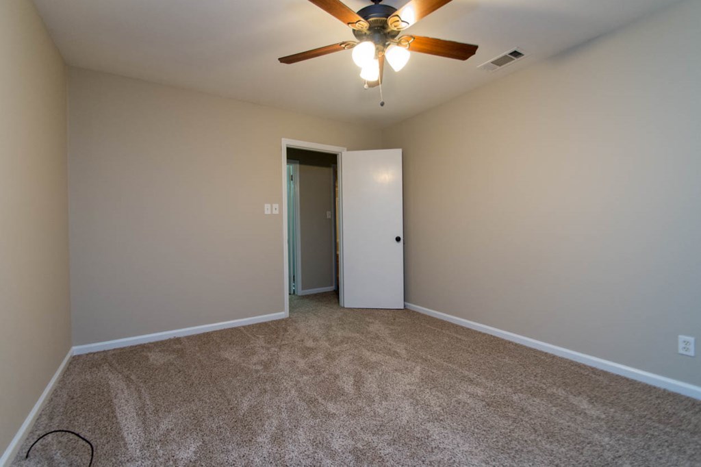 4841 Sandy Point Road Lizella, GA 31052 - Photo 32 of 42 an empty room with a chandelier fan and a chandelier fan
