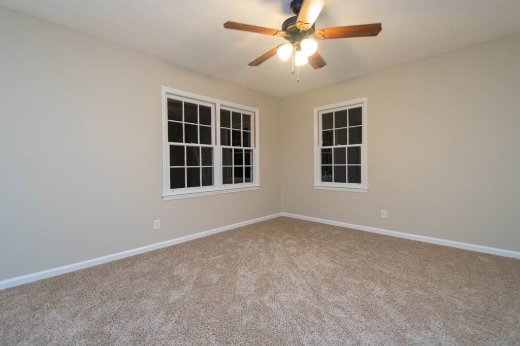 4841 Sandy Point Road Lizella, GA 31052 - Photo 33 of 42 an empty room with windows and fan