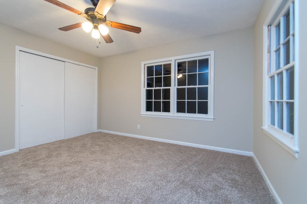4841 Sandy Point Road Lizella, GA 31052 - Photo 35 of 42 a view of an empty room with a window and kitchen view