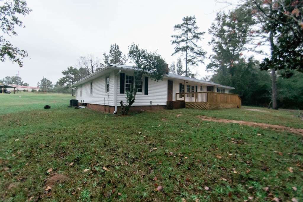 4841 Sandy Point Road Lizella, GA 31052 - Photo 41 of 42 a white house that has a tree in front of it