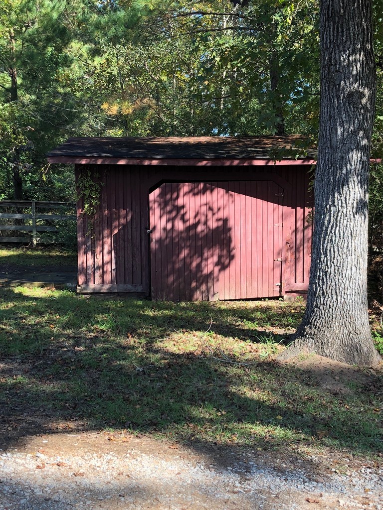 4841 Sandy Point Road Lizella, GA 31052 - Photo 6 of 42 a view of backyard with wooden fence and a large tree