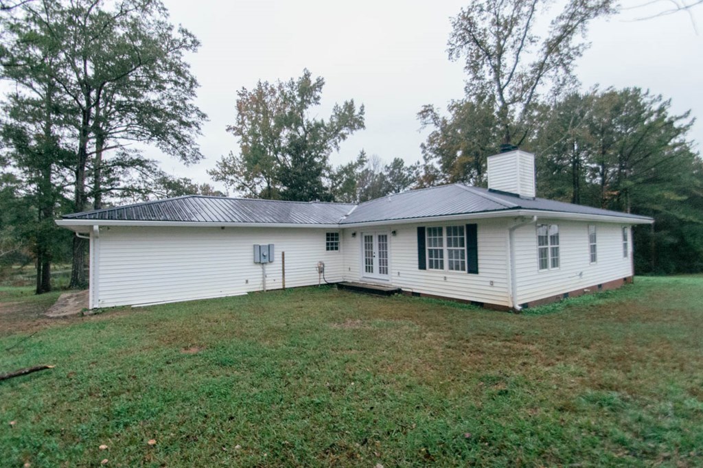 4841 Sandy Point Road Lizella, GA 31052 - Photo 7 of 42 a front view of a house with a garden