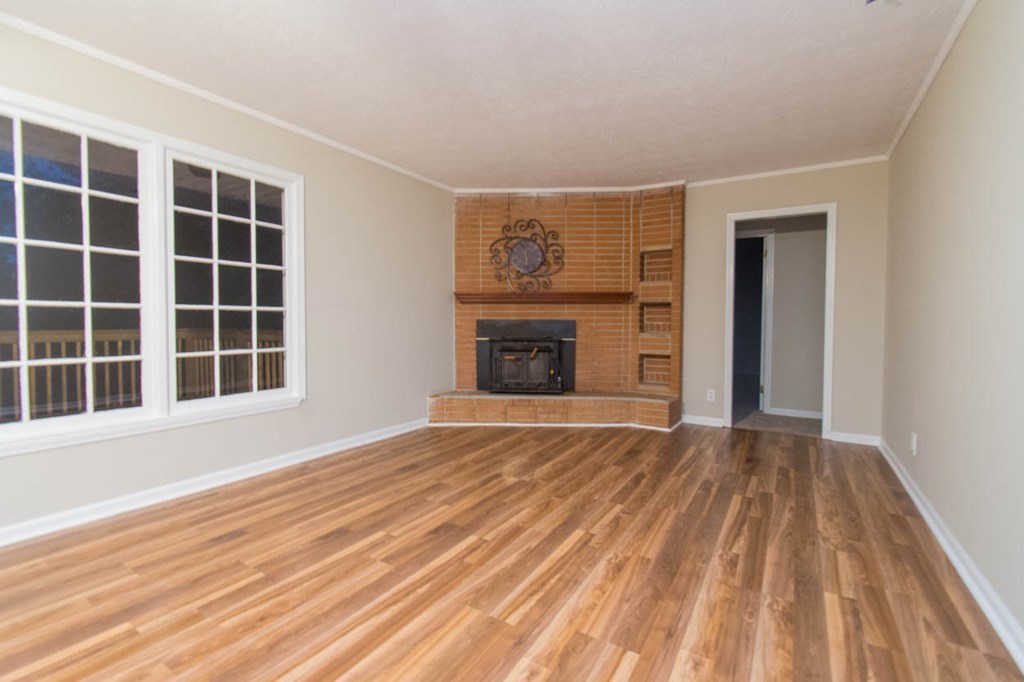 4841 Sandy Point Road Lizella, GA 31052 - Photo 8 of 42 a view of an empty room with a fireplace and a window