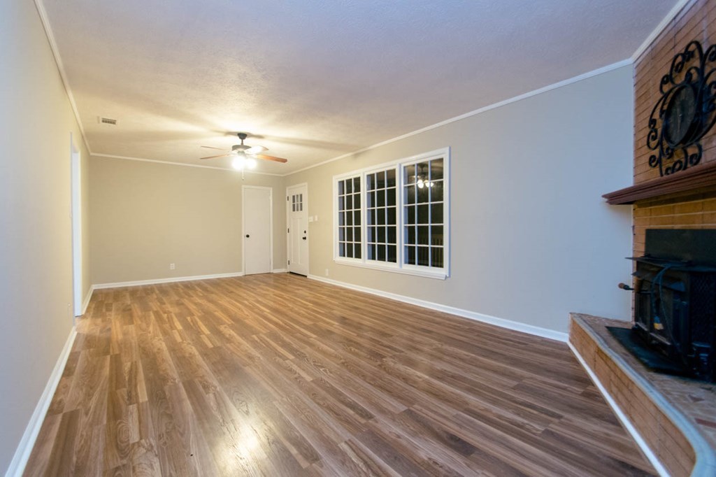 4841 Sandy Point Road Lizella, GA 31052 - Photo 9 of 42 a view of empty room with wooden floor and fan