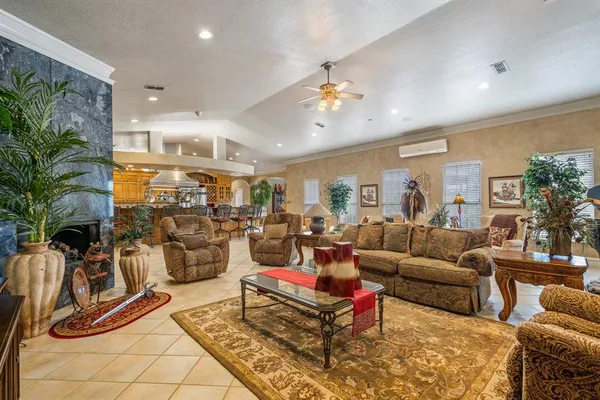 a living room with furniture a rug and a flat screen tv