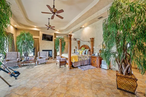 a living room with patio furniture and a potted plant