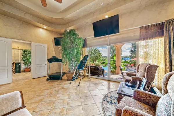 a living room with furniture a window and a potted plant