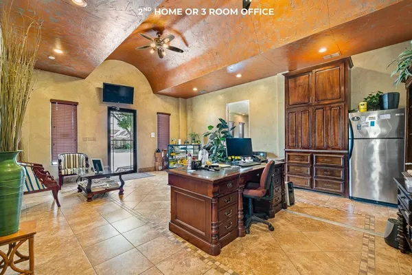 a view of living room filled with furniture and large windows
