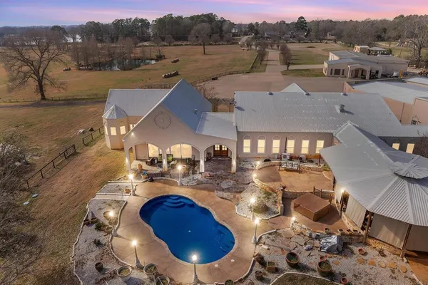 a view of a house with pool and chairs