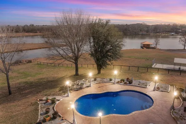 a view of a swimming pool with a lake view