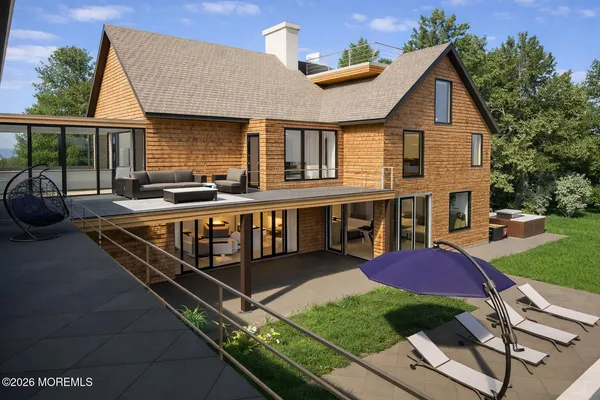 a view of a house with backyard and sitting area
