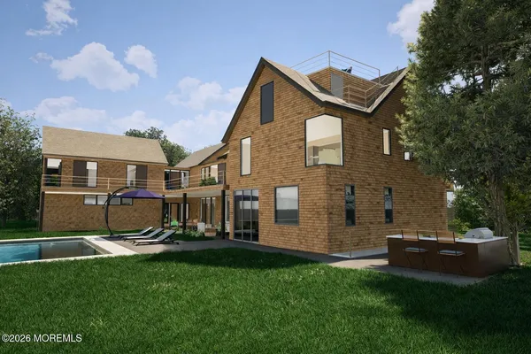 a view of a house with backyard and sitting area