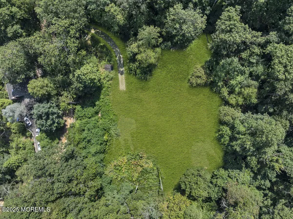 an aerial view of a houses with yard