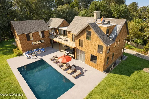 a aerial view of a house with a yard table and chairs