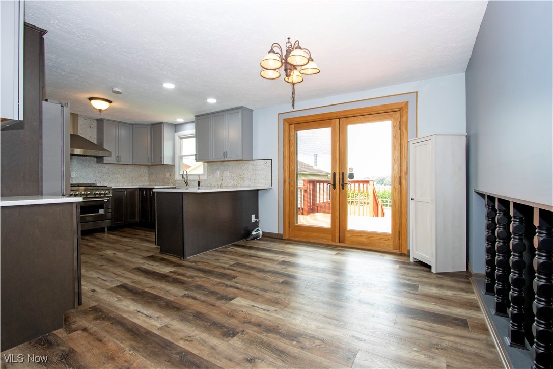2276 Schellin Road Wooster, OH 44691 - Photo 12 of 48 Kitchen with appliances with stainless steel finishes, light countertops, decorative backsplash, french doors, and dark wood-style floors
