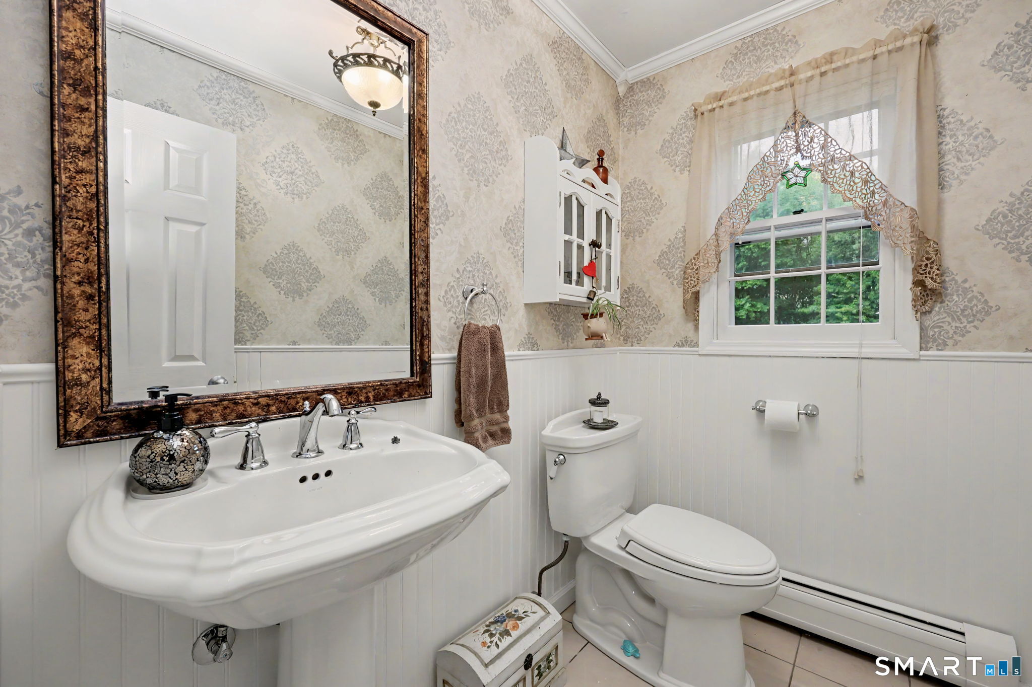 571 Wheeler Road Monroe, CT 06468 - Photo 13 of 40 a bathroom with a sink a toilet and a mirror