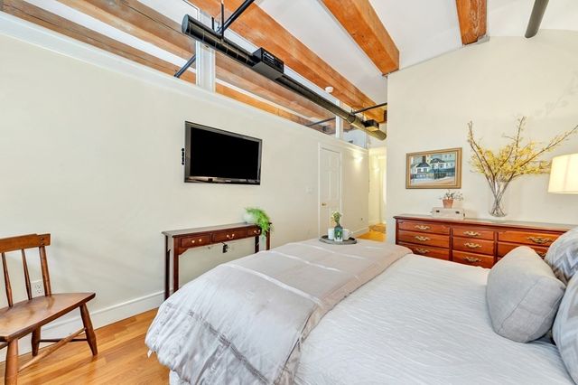 a bedroom with bed and a flat screen tv