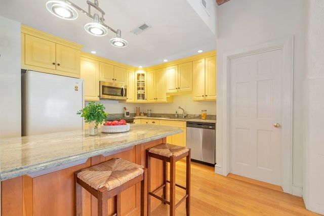 a kitchen with a refrigerator and a sink