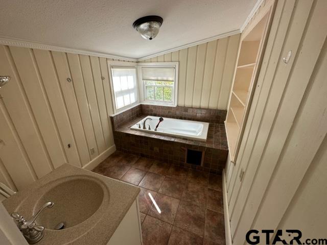 2002 South Robertson Avenue Tyler, TX 75701 - Photo 14 of 16 a bathroom with a sink a toilet and tub