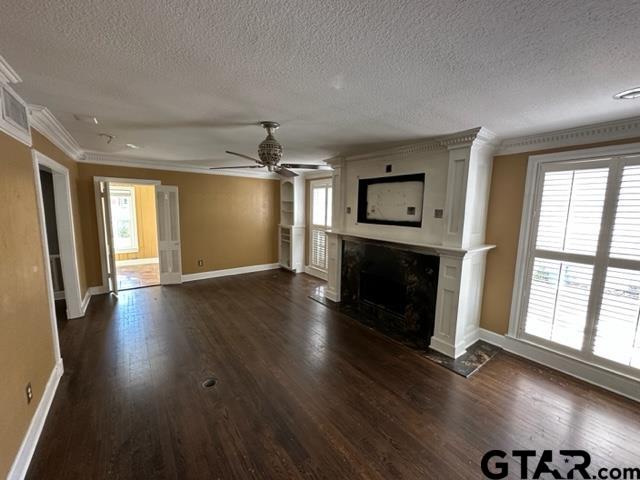 2002 South Robertson Avenue Tyler, TX 75701 - Photo 3 of 16 an empty room with wooden floor and fireplace