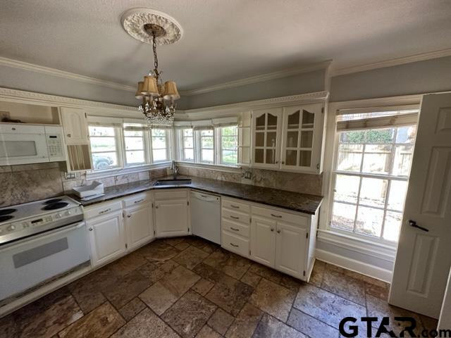 2002 South Robertson Avenue Tyler, TX 75701 - Photo 5 of 16 a kitchen with granite countertop a stove a sink and a chandelier