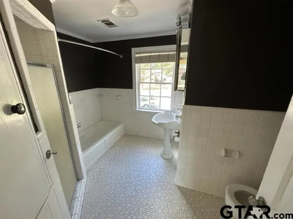 a bathroom with a bathtub sink and toilet