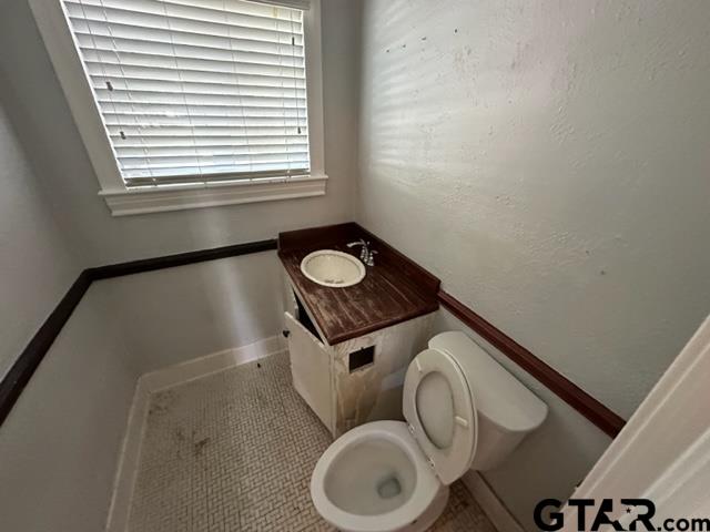 2002 South Robertson Avenue Tyler, TX 75701 - Photo 8 of 16 a bathroom with a toilet and a sink