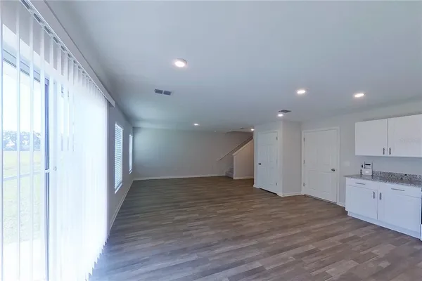 a view of a kitchen with a sink and wooden floor