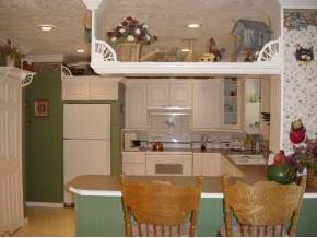 701 Northwest Rostock Palm Bay, FL 32907 - Photo 5 of 8 a kitchen with a sink and a refrigerator
