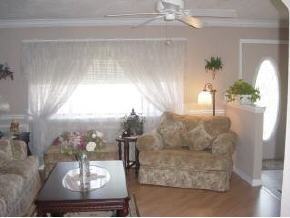 701 Northwest Rostock Palm Bay, FL 32907 - Photo 7 of 8 a living room with furniture and a chandelier