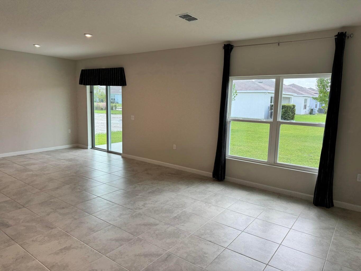 345 Clementine Road Fort Pierce, FL 34981 - Photo 11 of 13 a view of an empty room with a window