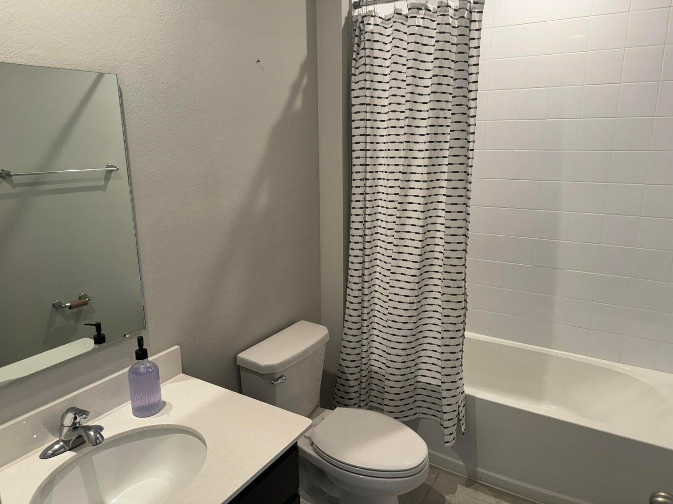345 Clementine Road Fort Pierce, FL 34981 - Photo 2 of 13 a bathroom with a sink a toilet and shower