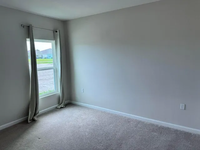 a view of an empty room and a window