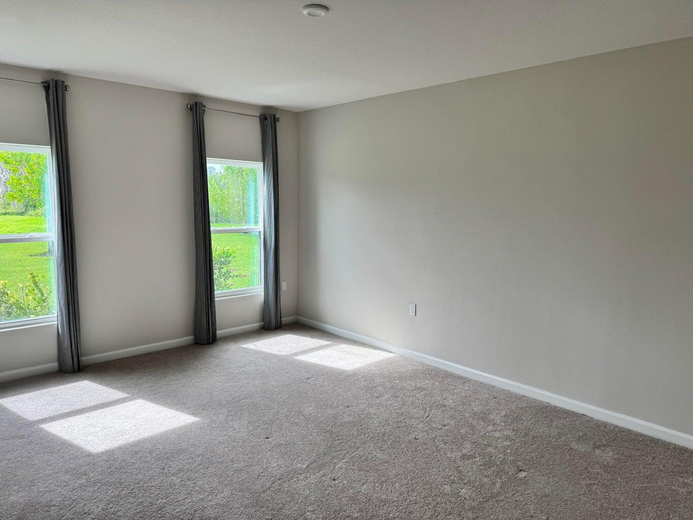 345 Clementine Road Fort Pierce, FL 34981 - Photo 7 of 13 an empty room with windows