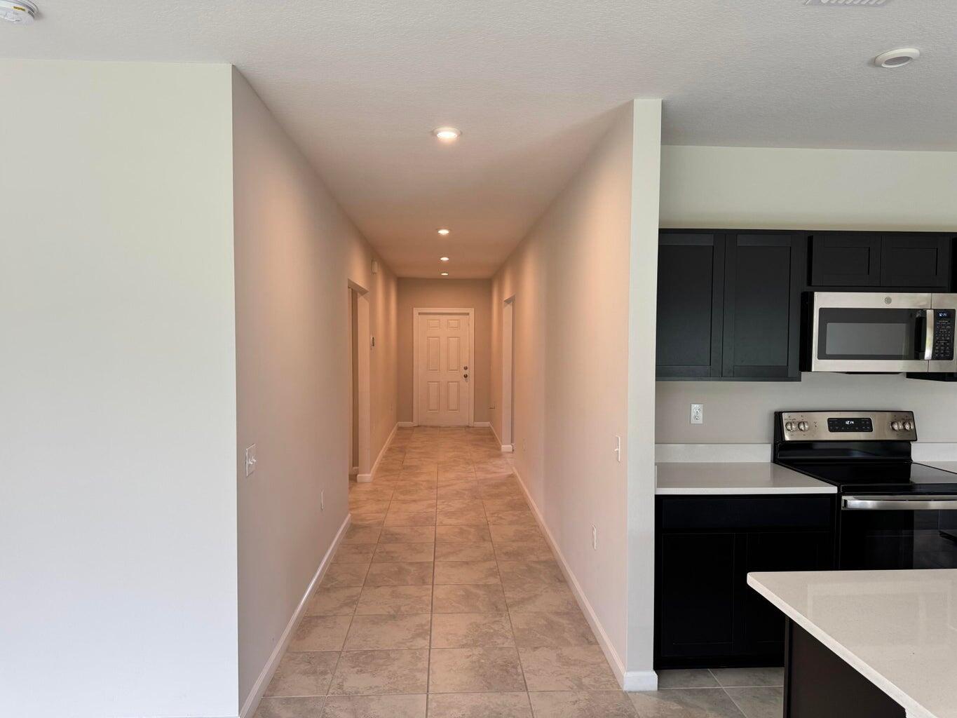 345 Clementine Road Fort Pierce, FL 34981 - Photo 8 of 13 a view of a kitchen from the hallway