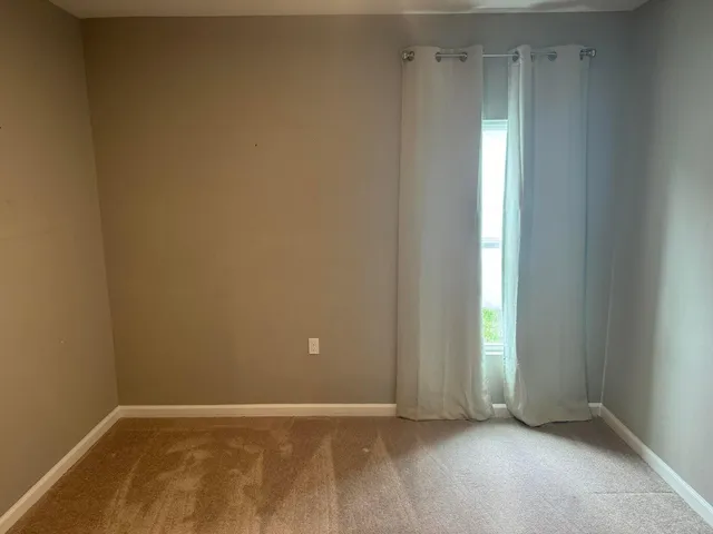 a view of an empty room with closet area