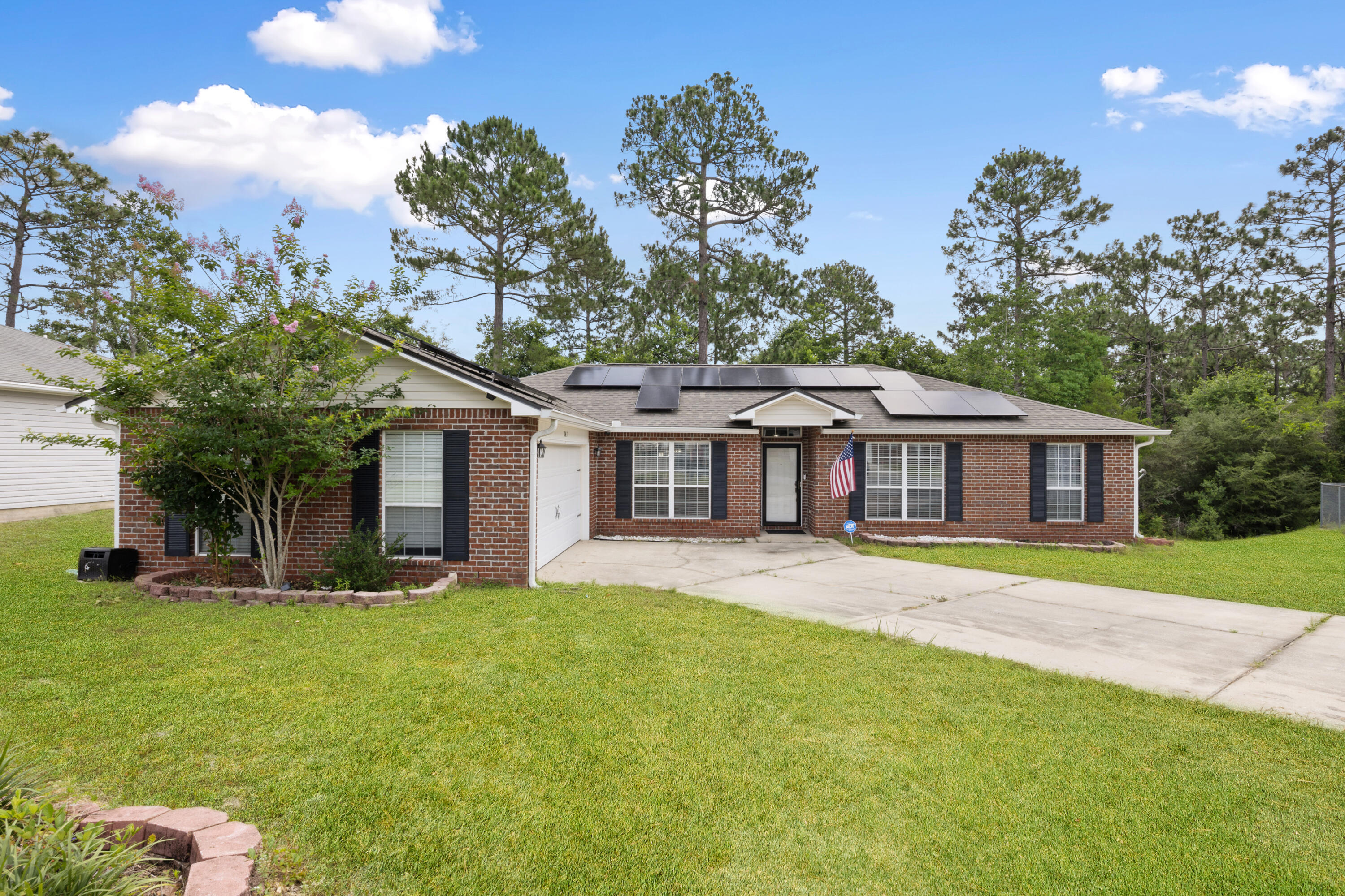 143 Sandstone Trail Crestview, FL 32539 - Photo 1 of 40 a front view of a house with a garden