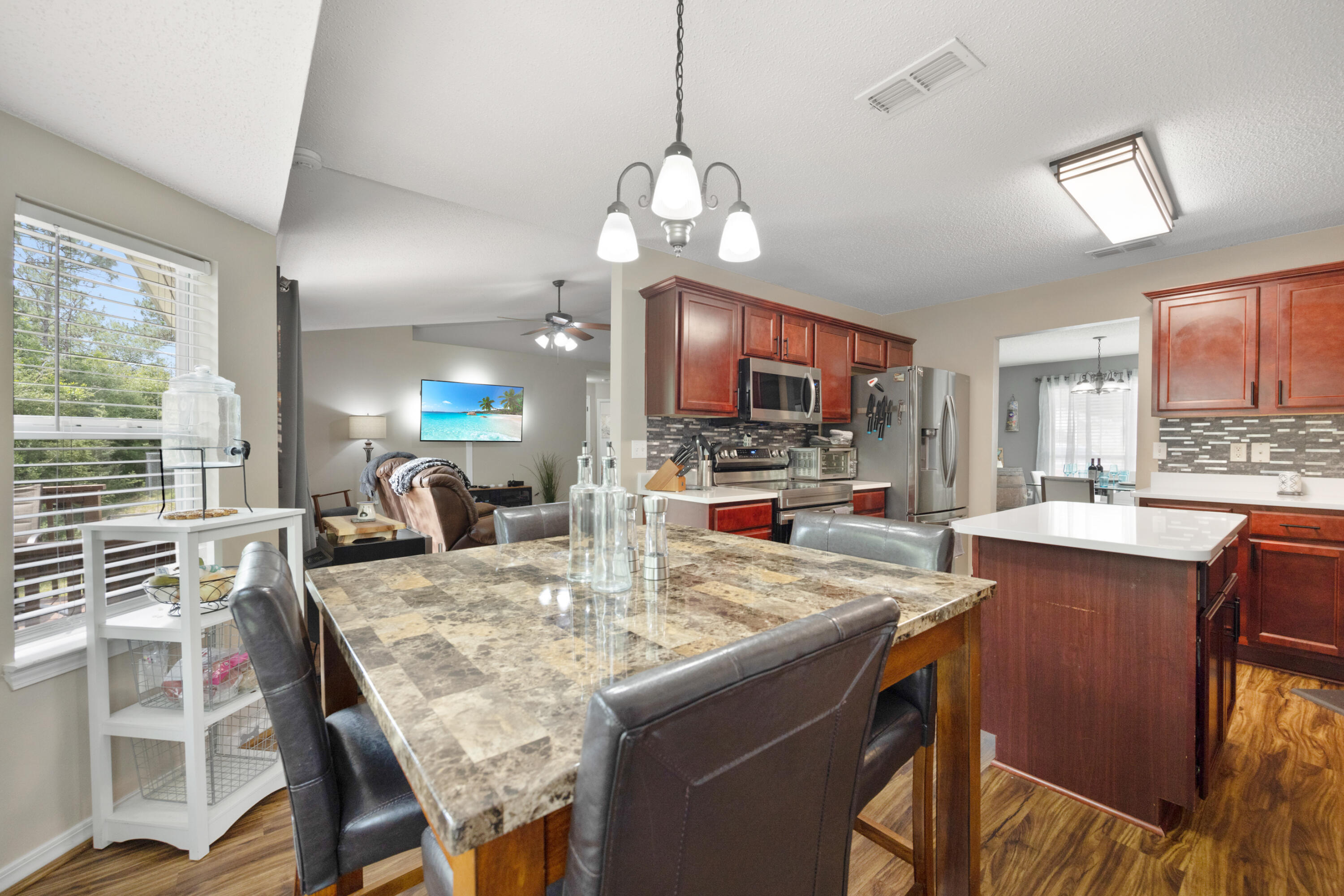 143 Sandstone Trail Crestview, FL 32539 - Photo 14 of 40 a view of kitchen with sink refrigerator dining table and chairs