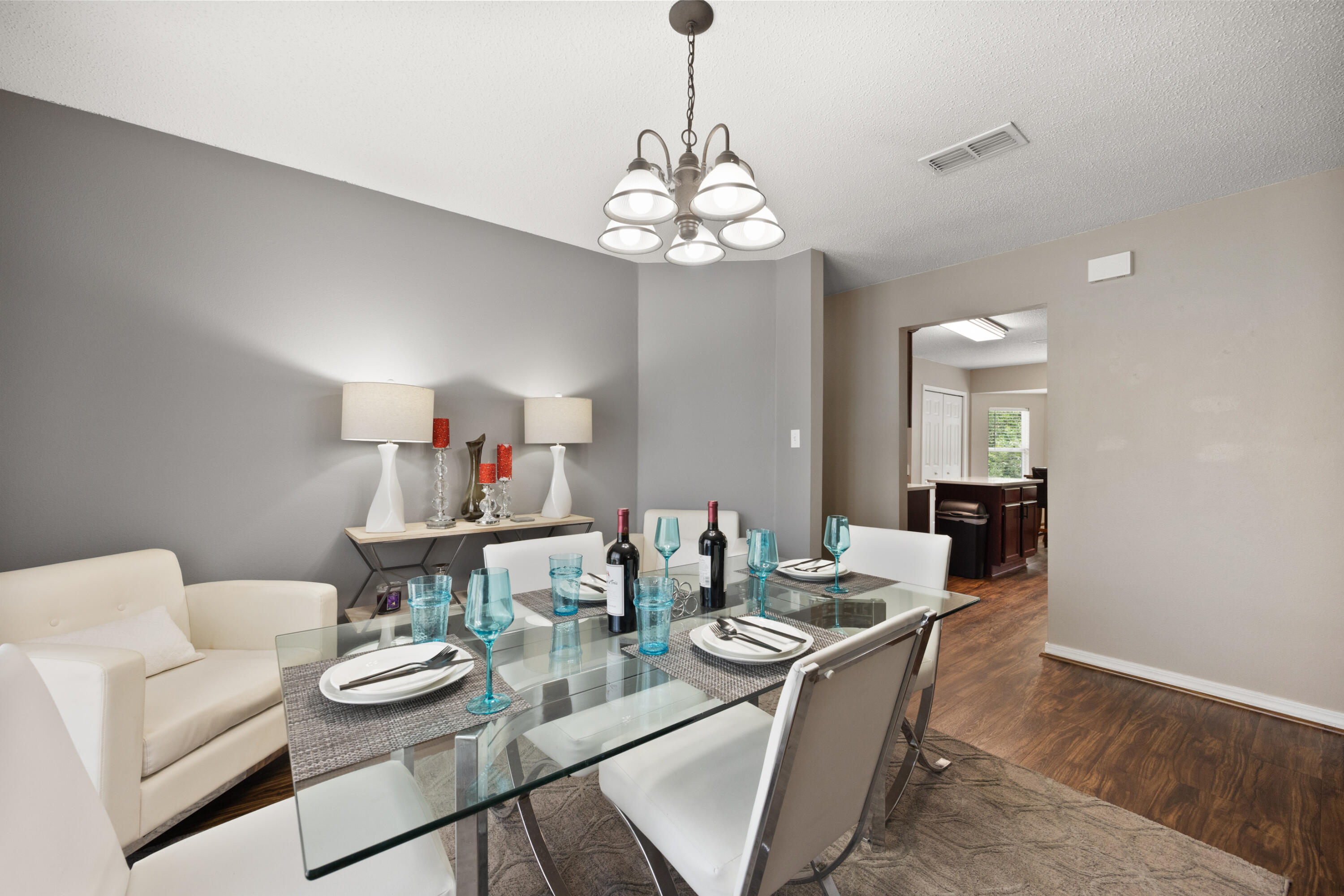 143 Sandstone Trail Crestview, FL 32539 - Photo 17 of 40 a view of a dining room with furniture wooden floor and a chandelier