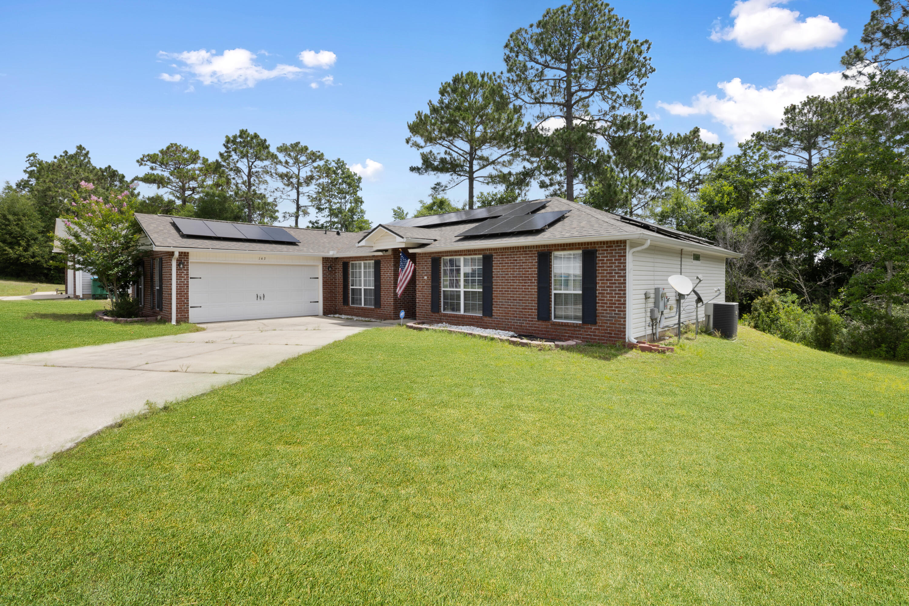 143 Sandstone Trail Crestview, FL 32539 - Photo 2 of 40 a front view of a house with a garden