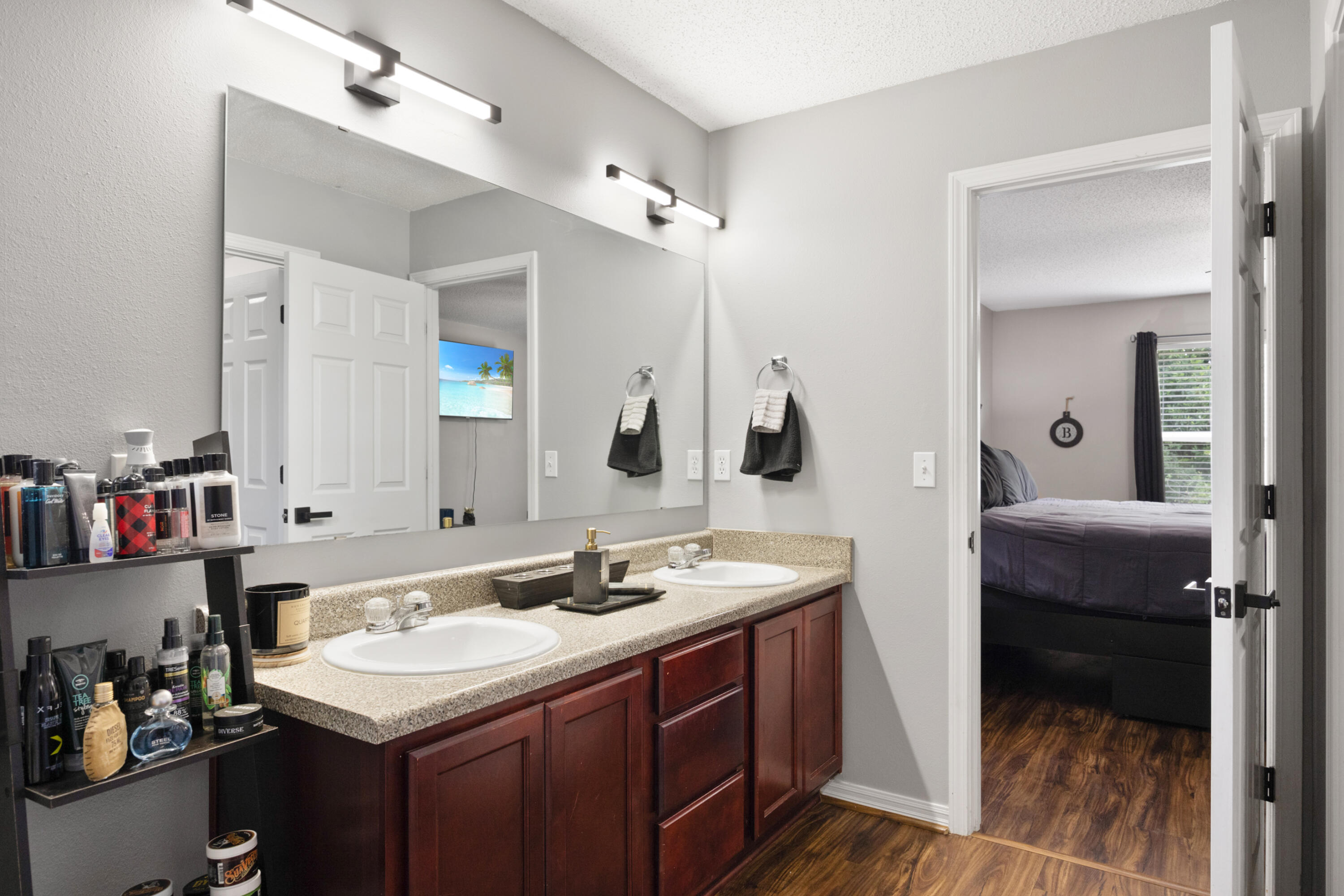 143 Sandstone Trail Crestview, FL 32539 - Photo 22 of 40 a en suite bathroom with a sink double vanity and a mirror