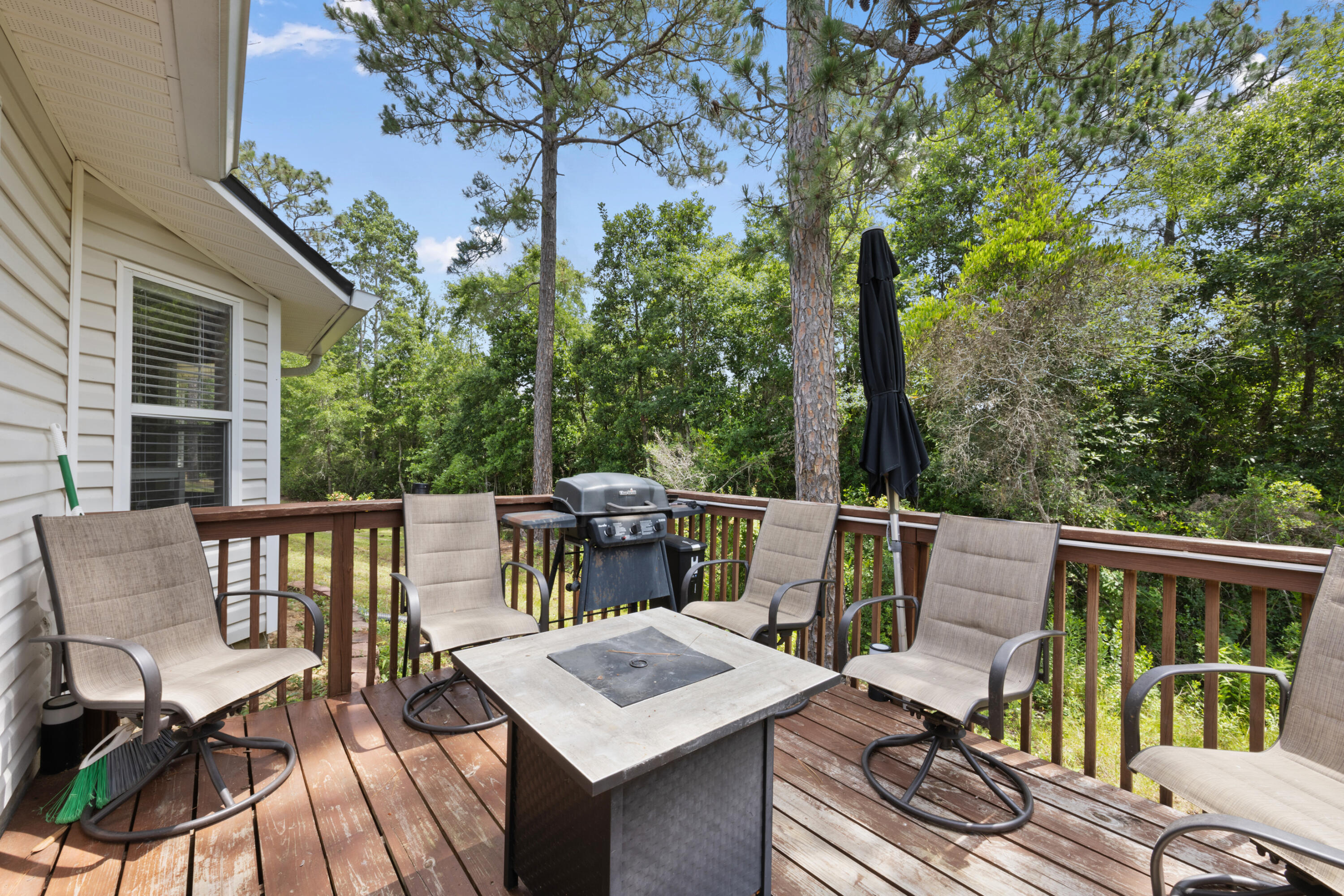 143 Sandstone Trail Crestview, FL 32539 - Photo 33 of 40 a view of a patio with a table chairs and wooden fence
