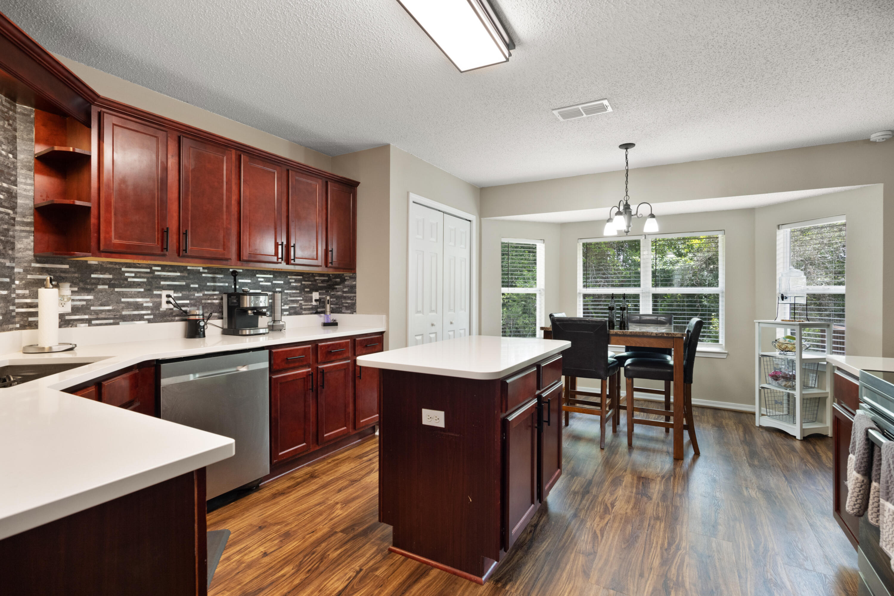 143 Sandstone Trail Crestview, FL 32539 - Photo 10 of 40 a kitchen with stainless steel appliances granite countertop sink stove top oven and cabinets