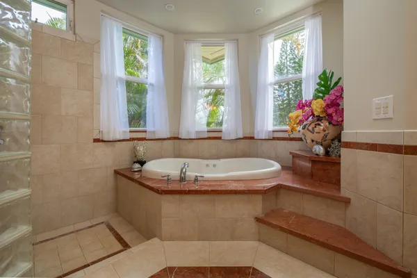 a bedroom with a bed and ceiling fan